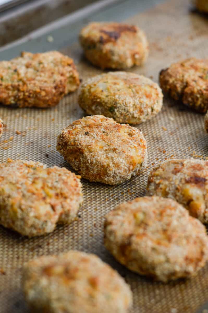 Close up of crispy homemade ground chicken nuggets on a tray.