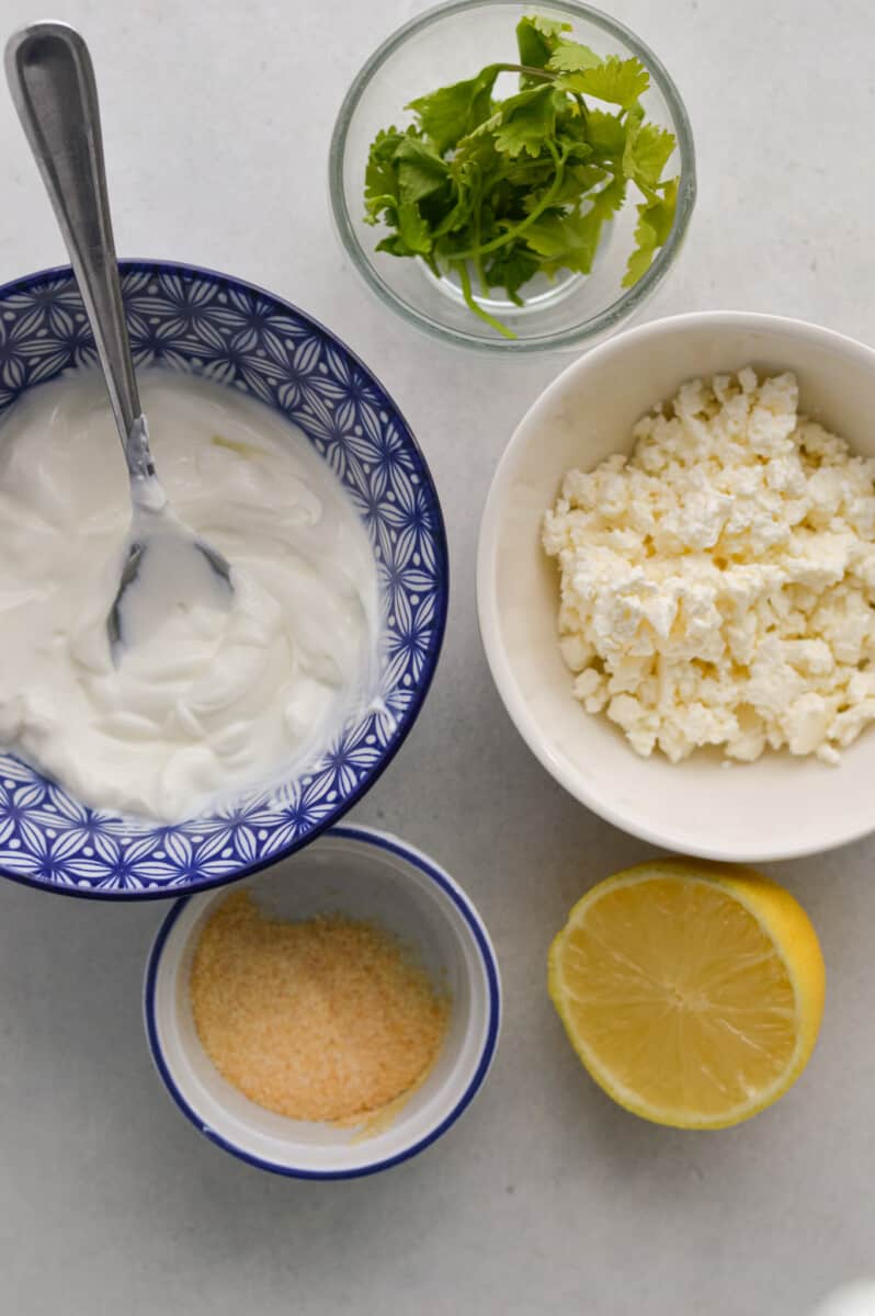 Ingredients including Greek yogurt, feta, cilantro and garlic powder.