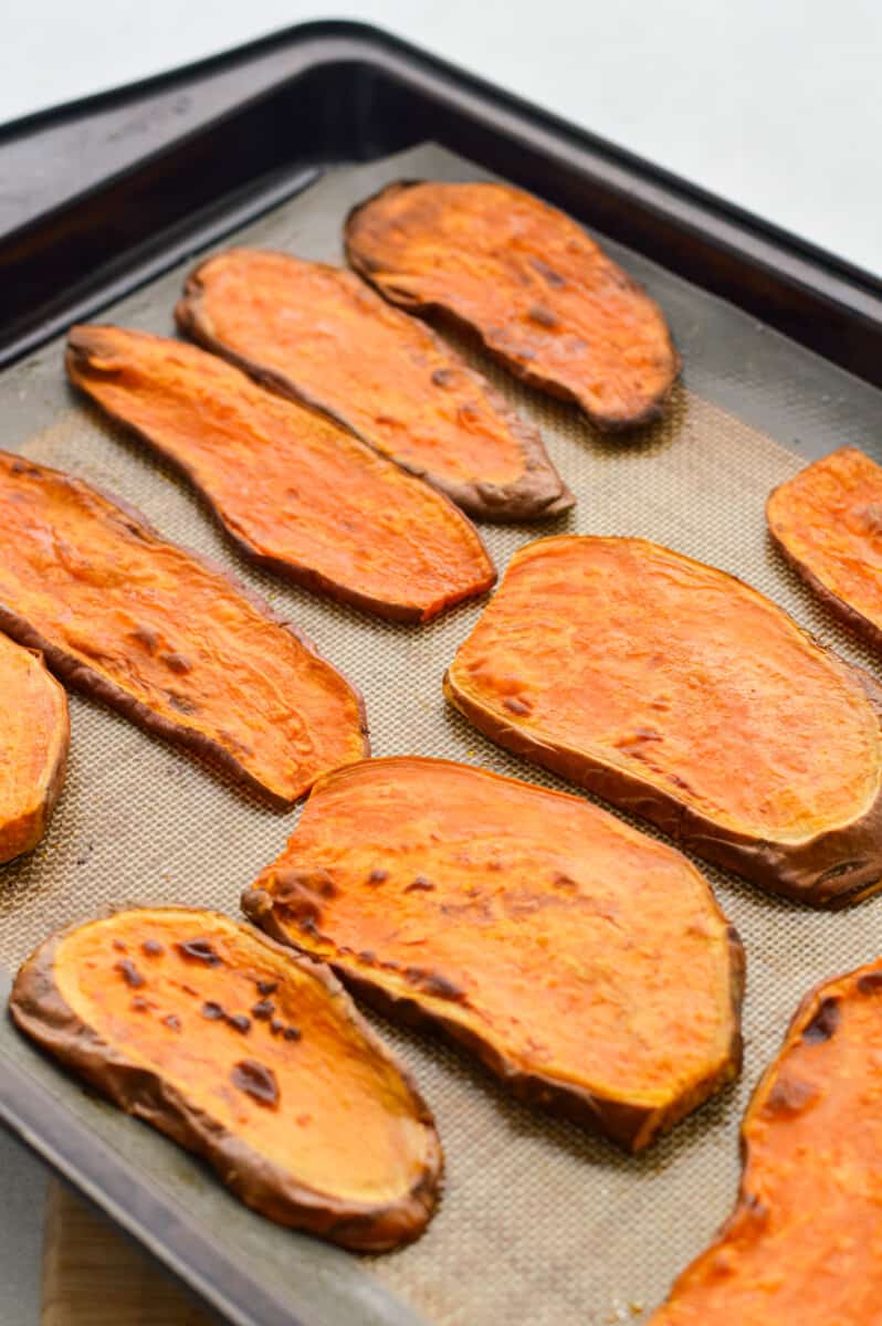 Baked slices of sweet potato toast on a tray.