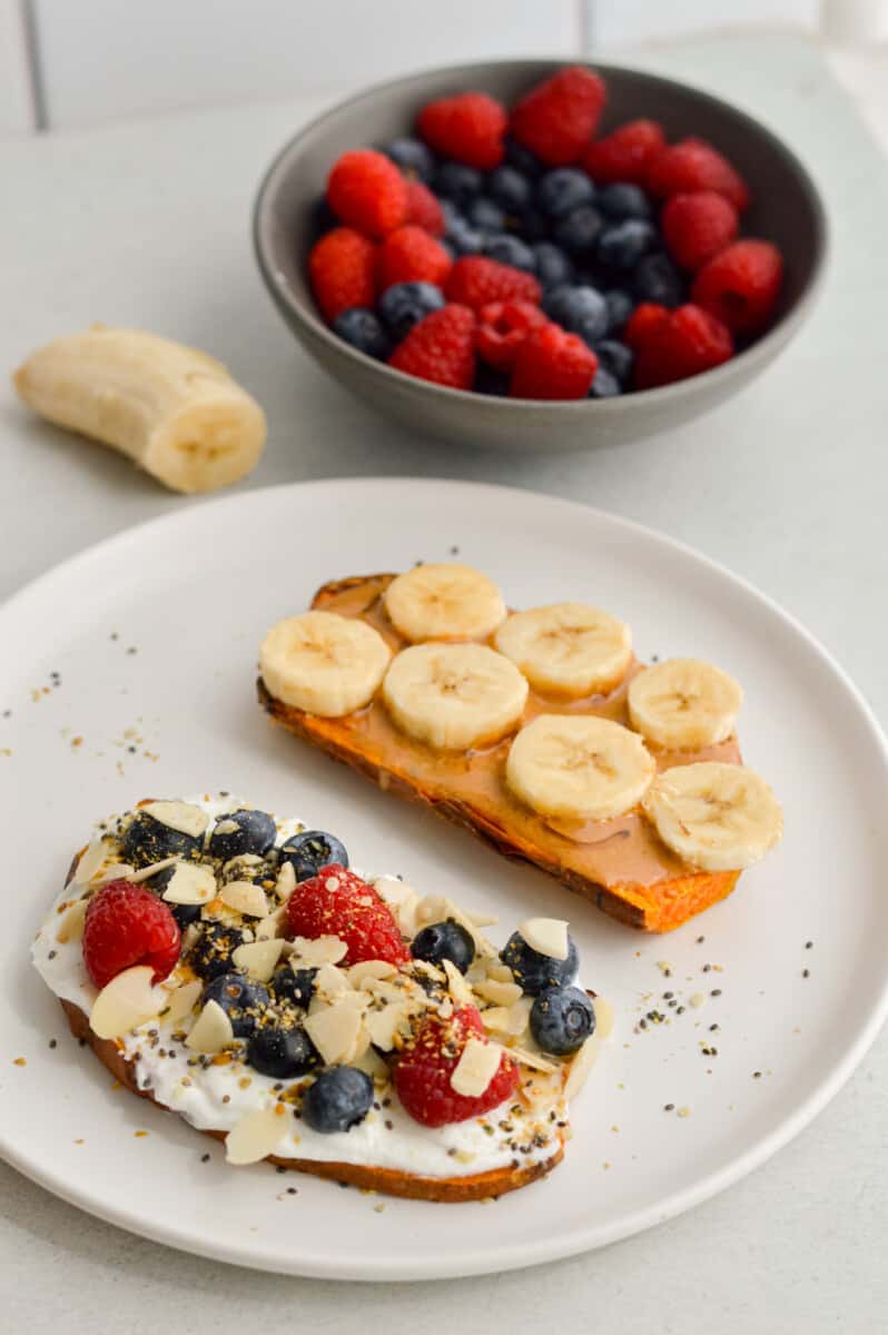 Plate of peanut butter banana sweet potato toast and yogurt berry sweet potato toast.