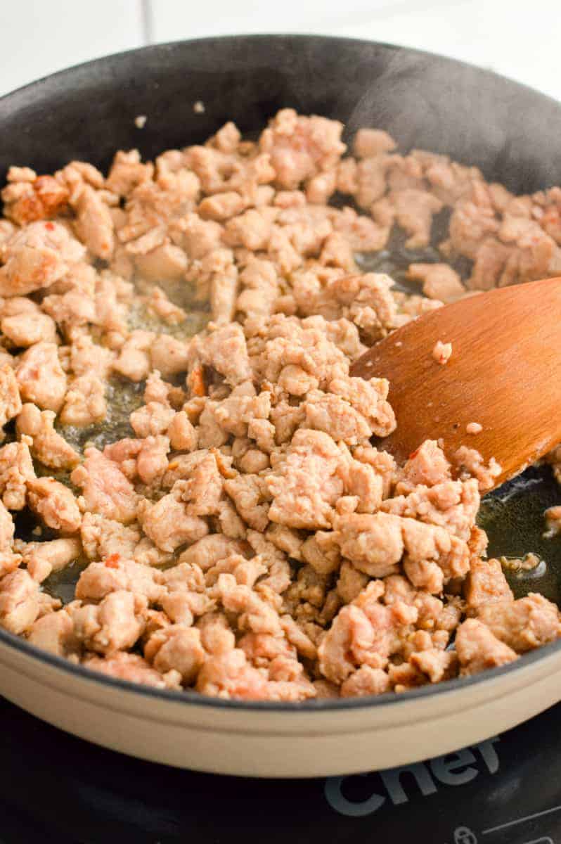Cooking ground turkey sausage.