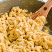 Stirring a pot of cottage cheese mac and cheese.