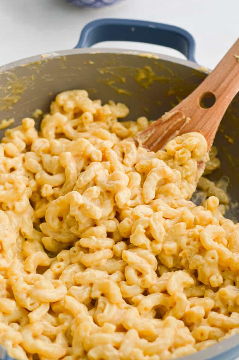 Stirring a pot of cottage cheese mac and cheese.