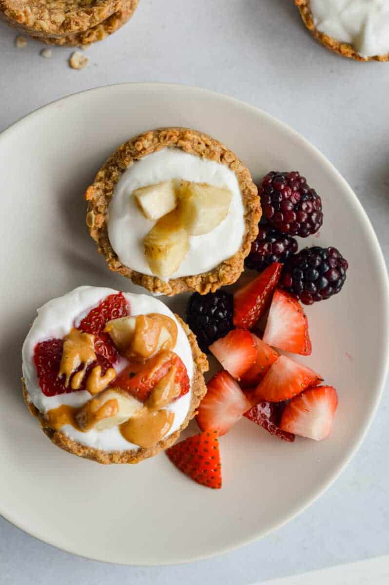 Plate with two granola cups filled with yogurt and fruit.