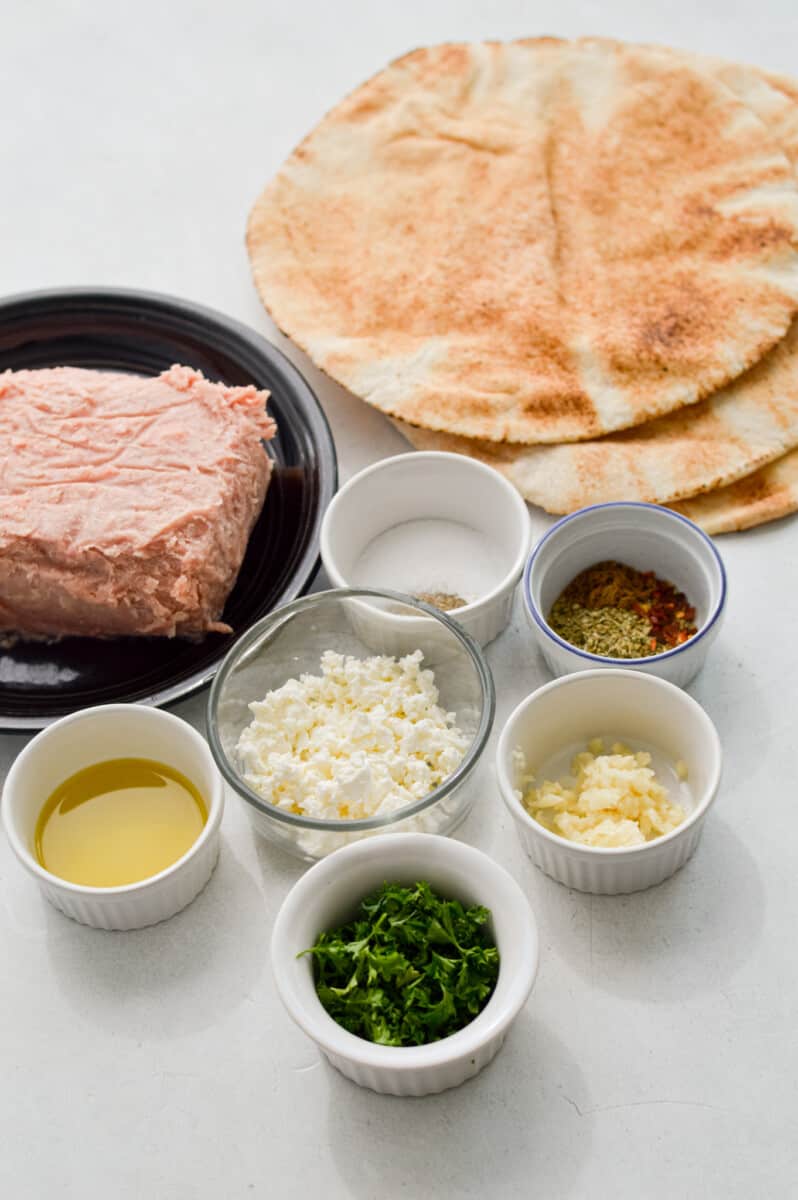 Ingredients including pita, turkey, feta, parsley, garlic and olive oil.