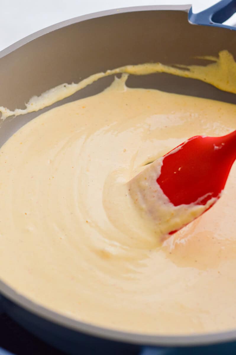 Cooking cottage cheese pasta sauce in a pan.