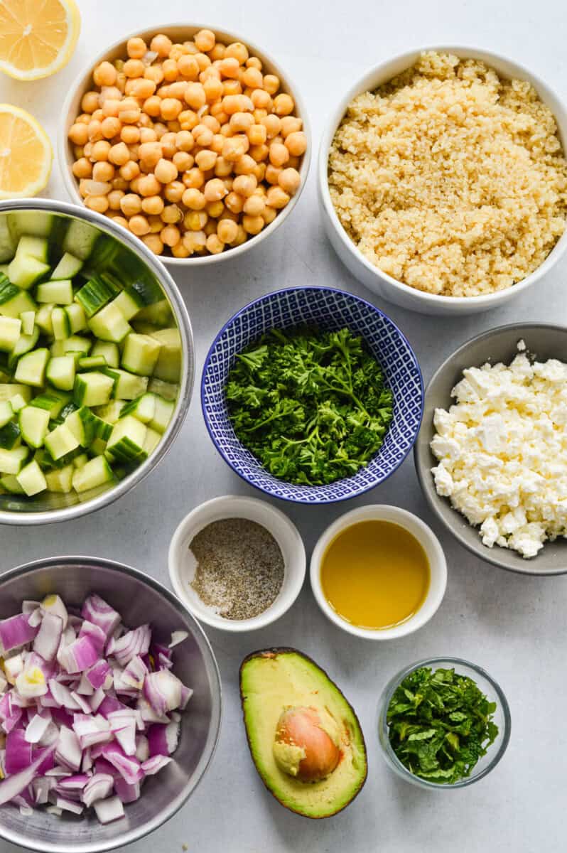 Measured ingredients including quinoa, chickpeas, cucumber, herbs, olive oil, avocado, red onion, feta cheese and lemon juice.