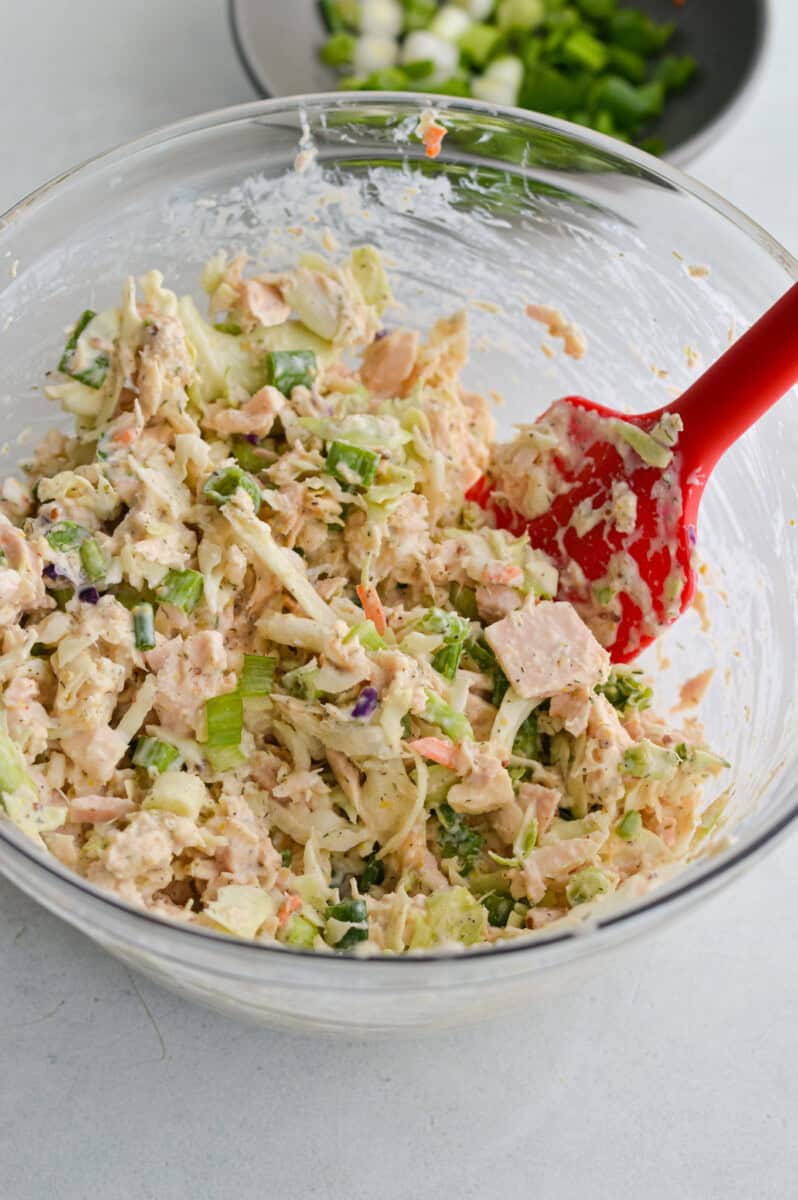 Mixing tuna salad filling.