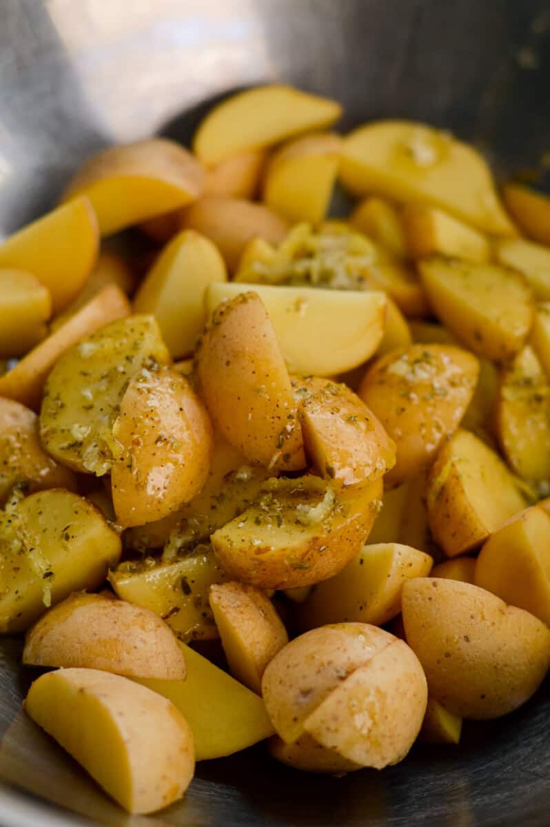 Close up of marinated potatoes on a sheet pan.