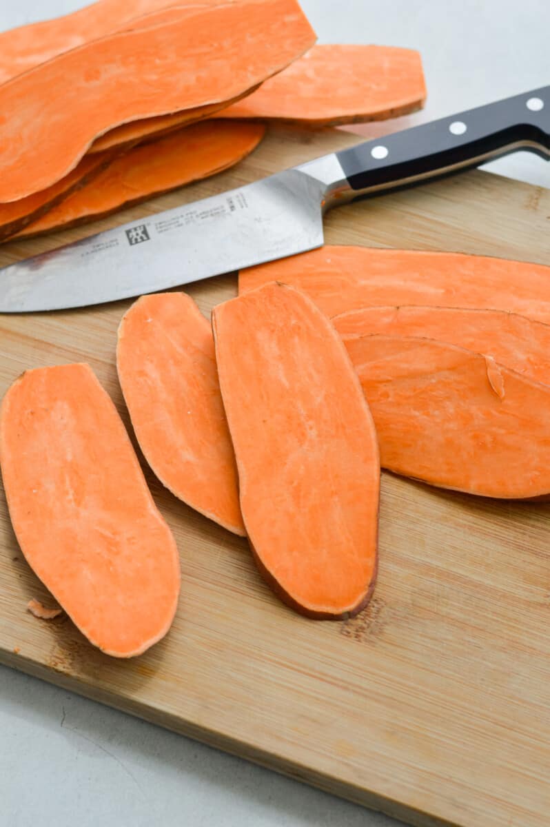 Slicing sweet potatoes into toast shapes.