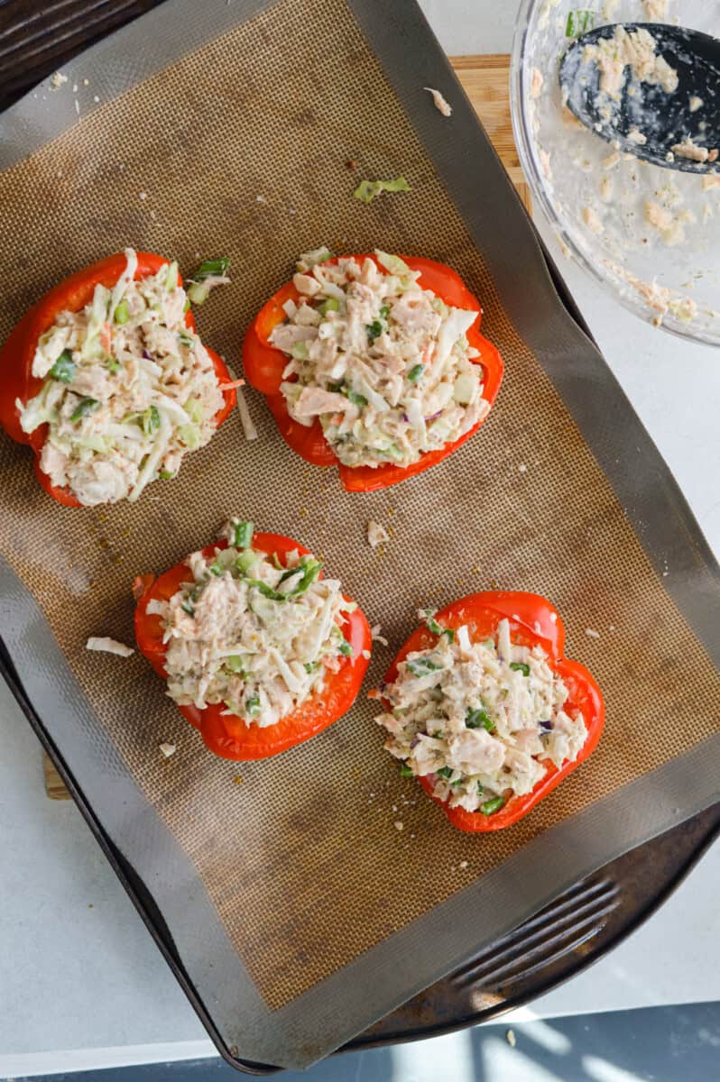 Stuffing red bell peppers with buffalo ranch tuna salad.