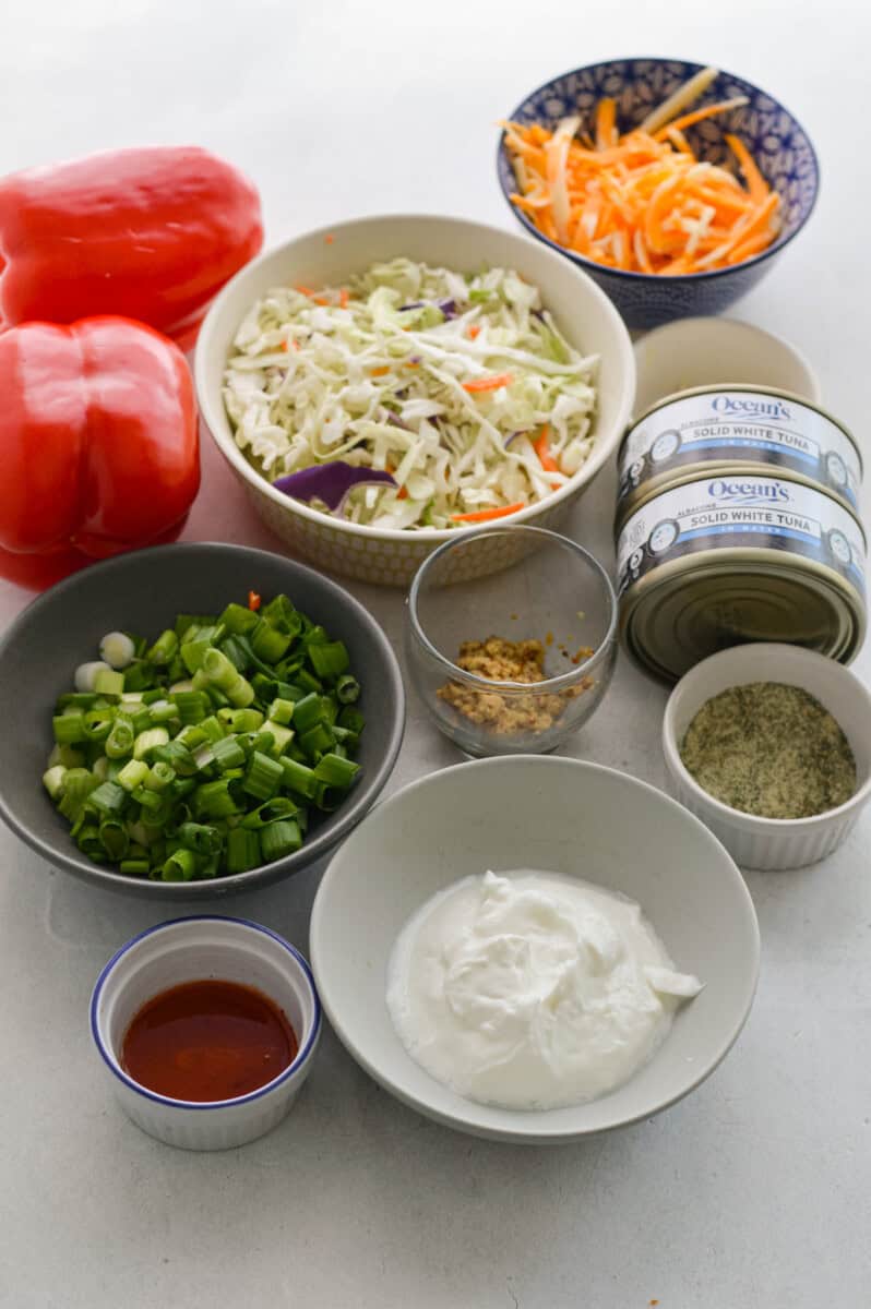 Ingredients including red bell pepper, green onion, mayonnaise, greek yogurt, ranch seasoning, tuna, spices, buffalo sauce and ranch dressing.