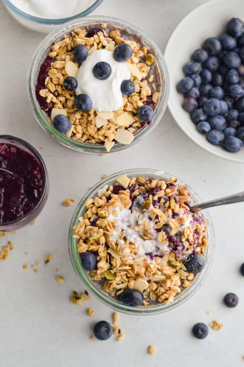 Birds eye with two jars of blueberry overnight oats.