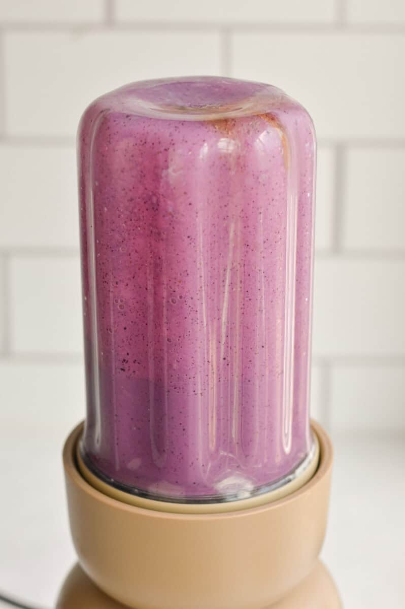 Blending blueberry milk by combining milk, vanilla Greek yogurt, ¼ cup of blueberries, honey, vanilla extract and lemon juice. 
