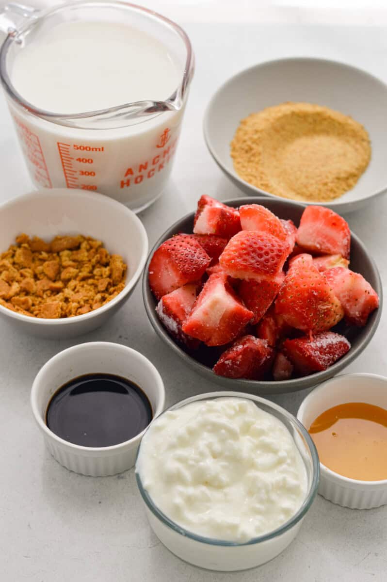 Ingredients including frozen strawberries, milk, flax, cottage cheese, vanilla, and honey.