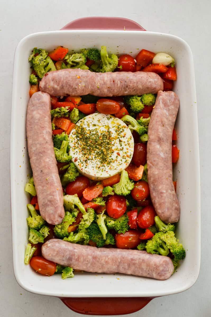Adding 4 turkey sausages around the feta and veggies.