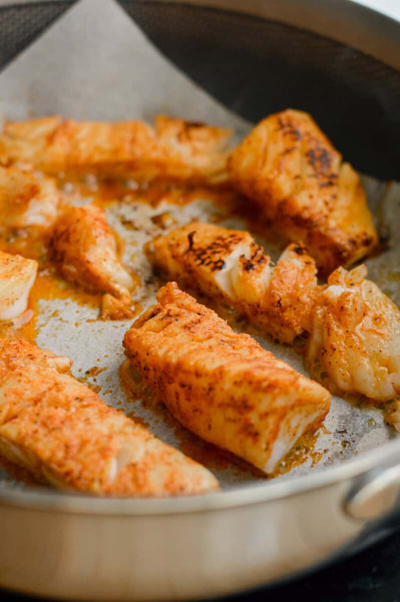 Cooking fish on a pan.