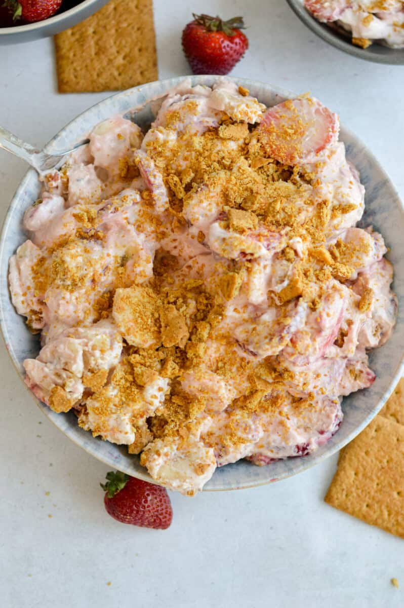 Birds eye of strawberry and banana cheesecake salad with graham cracker crumbs on top.
