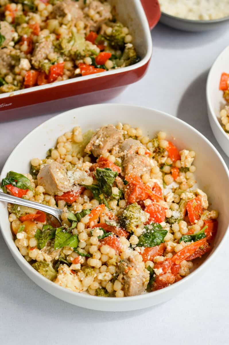 Bowl of baked feta couscous with sausage.