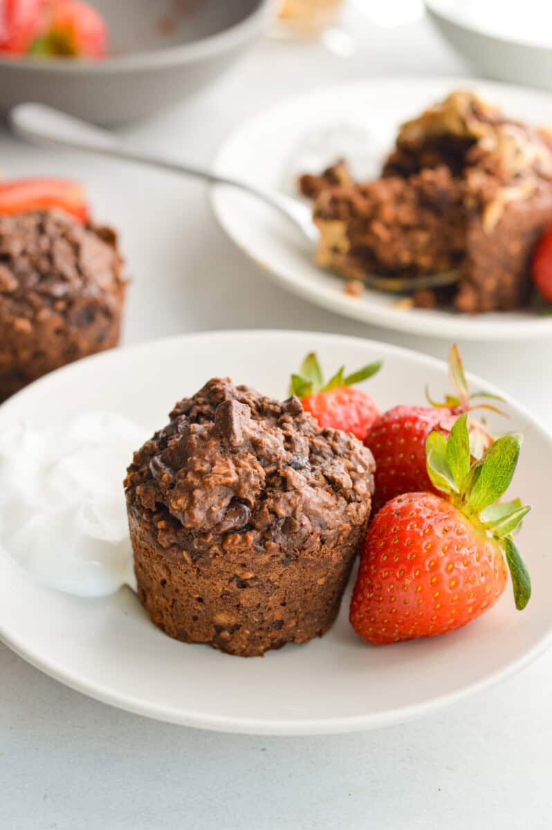Plate with a chocolate baked oat cup, strawberries and yogurt.