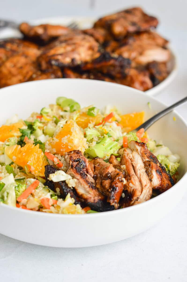 Grilled chicken thighs on a salad.