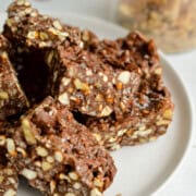 Close up of chocolate peanut butter crunch bars on a plate.