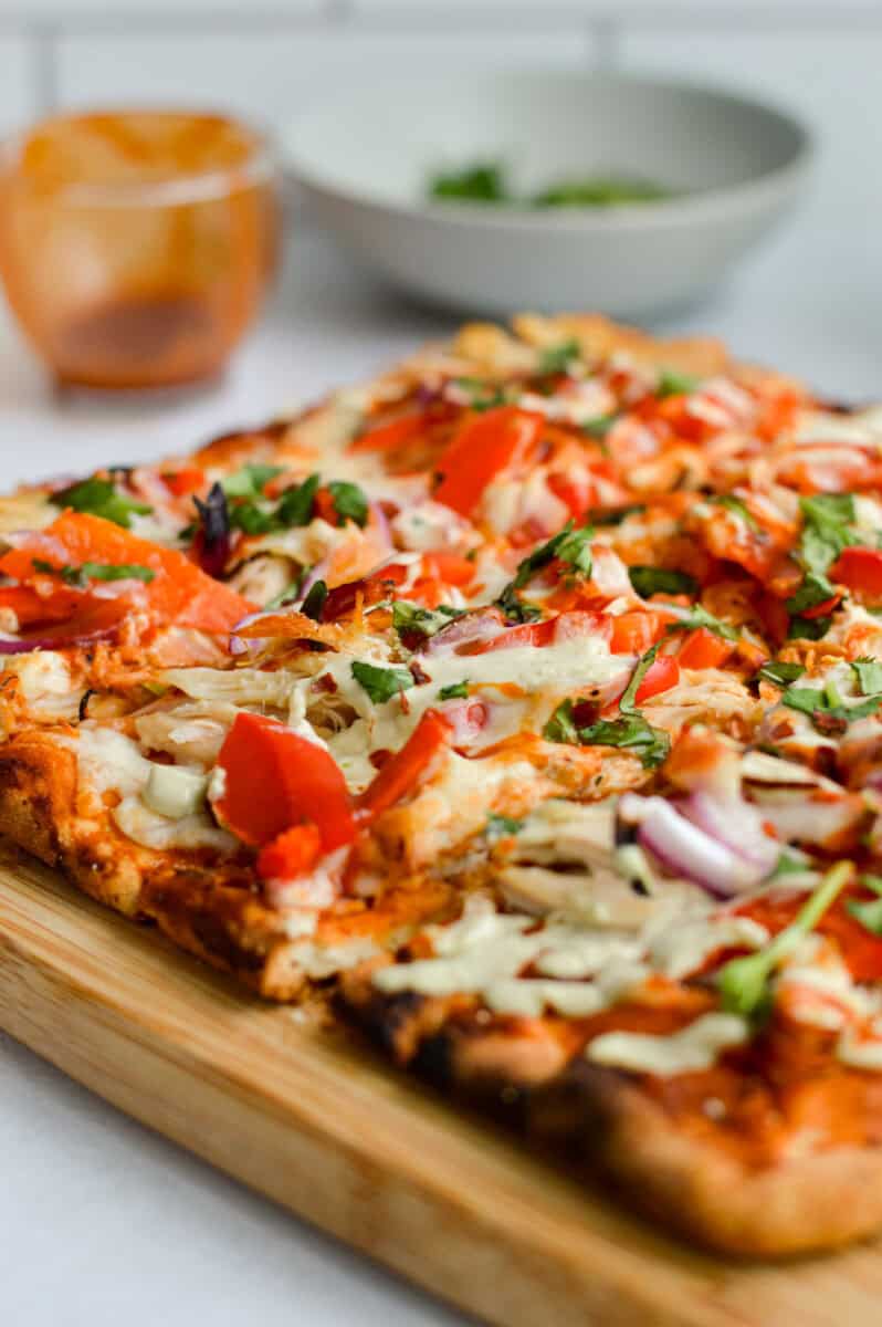 Close up of loaded bbq chicken flatbread.