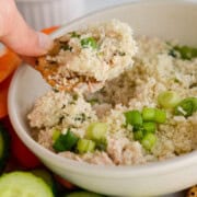 Dipping a cracker in tuna dip.