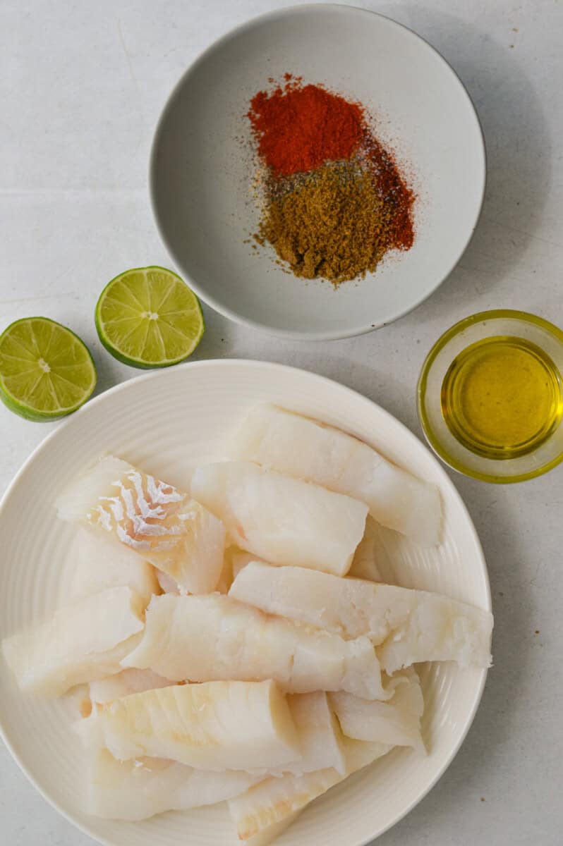 Ingredients including white fish, olive oil, lime and seasoning.