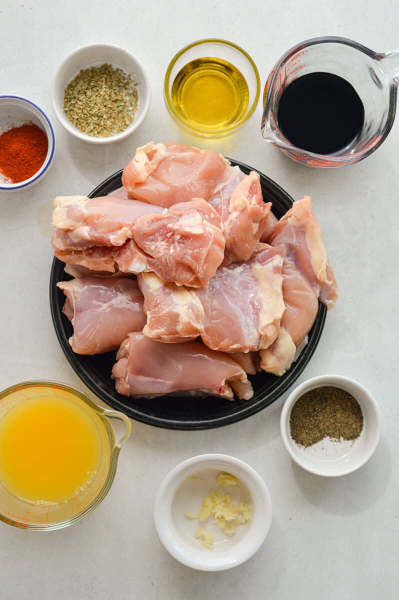 Ingredients includign boneless skinless chicken thighs, orange juice, spices, soy sauce, olive oil and garlic.