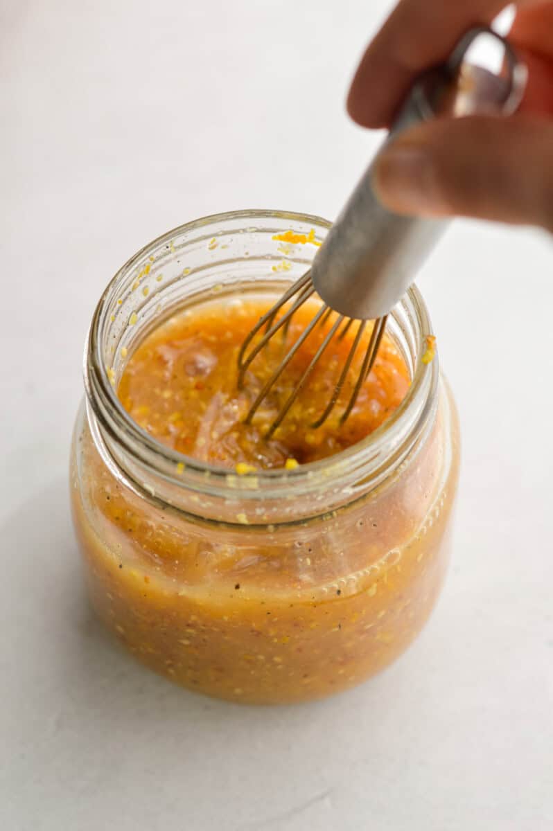 In a small bowl or mason jar, combine orange juice, orange zest, honey, dijon mustard, salt, black pepper and red wine vinegar