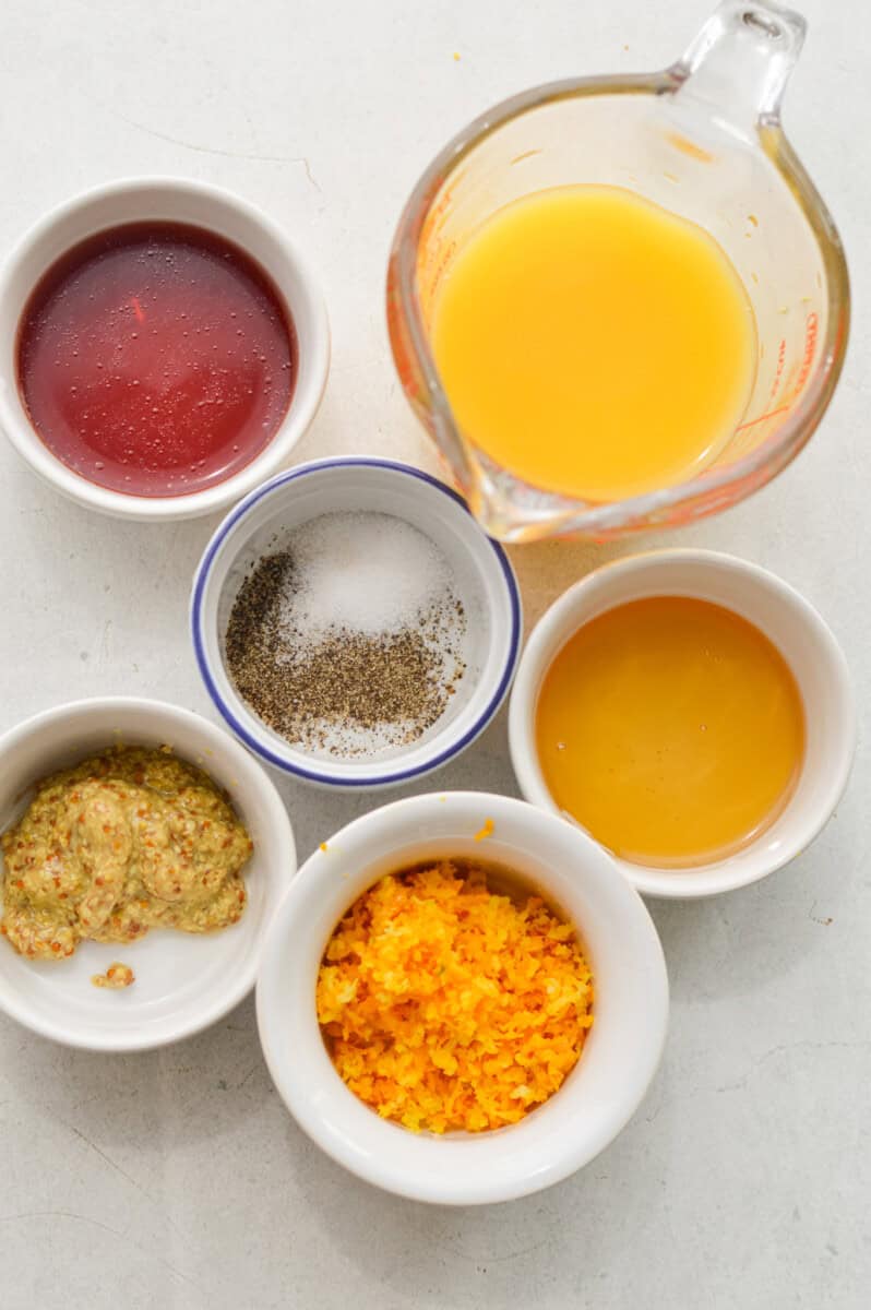 Ingredients including orange juice, orange zest, red wine vinegar, seasoning and dijon mustard.