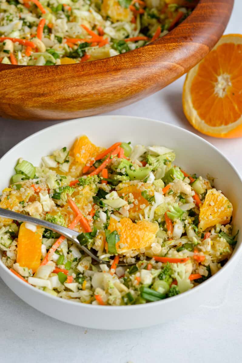 Serving a bowl of orange quinoa salad.