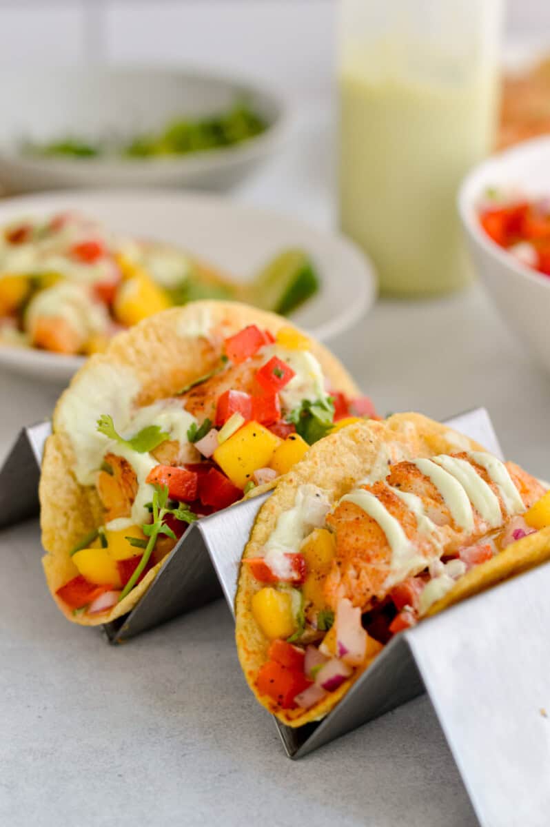Two fish tacos with mango salsa.