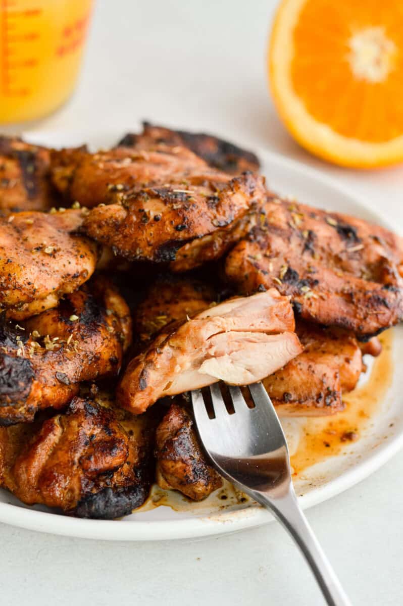 Cutting a slice of chicken thigh.