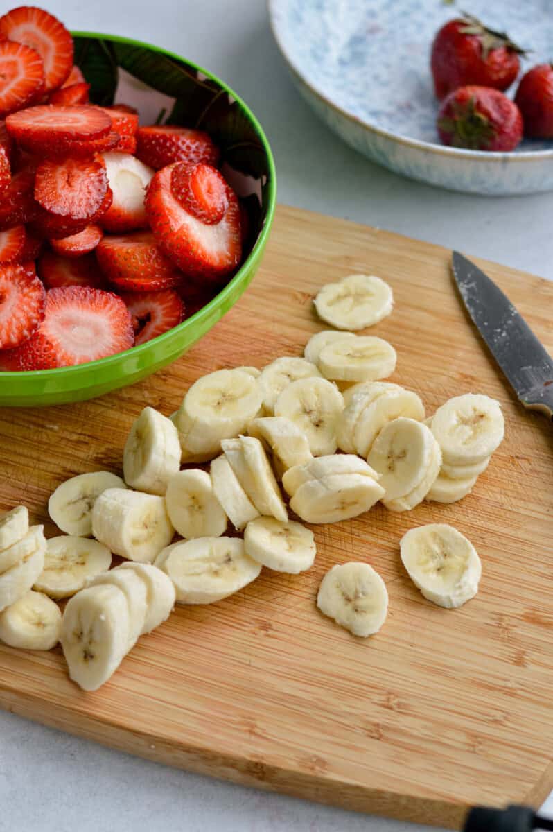 Slicing bananas and strawberries.