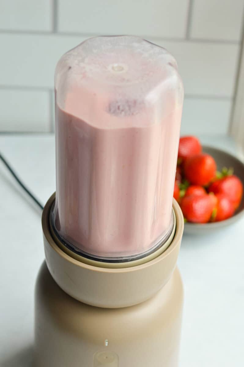 Making berry milk in a blender.