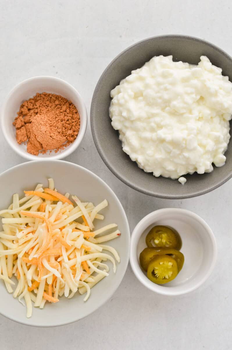 Ingredients including cottage cheese, shredded cheese, jalapenos, and taco seasoning.
