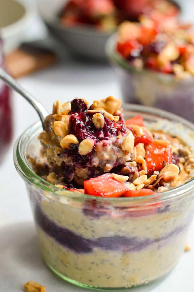 Scooping a bite of pb and j overnight oats.