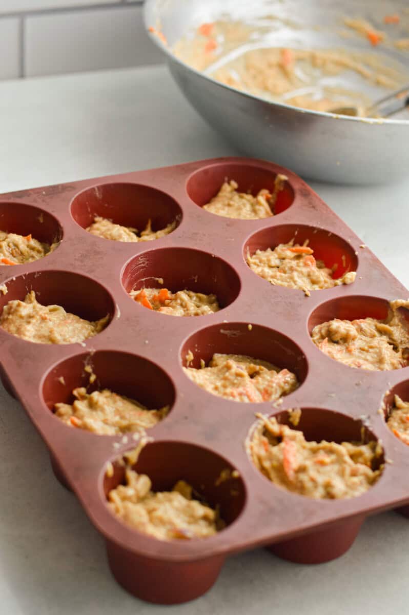 Dividing batter into muffin tin.