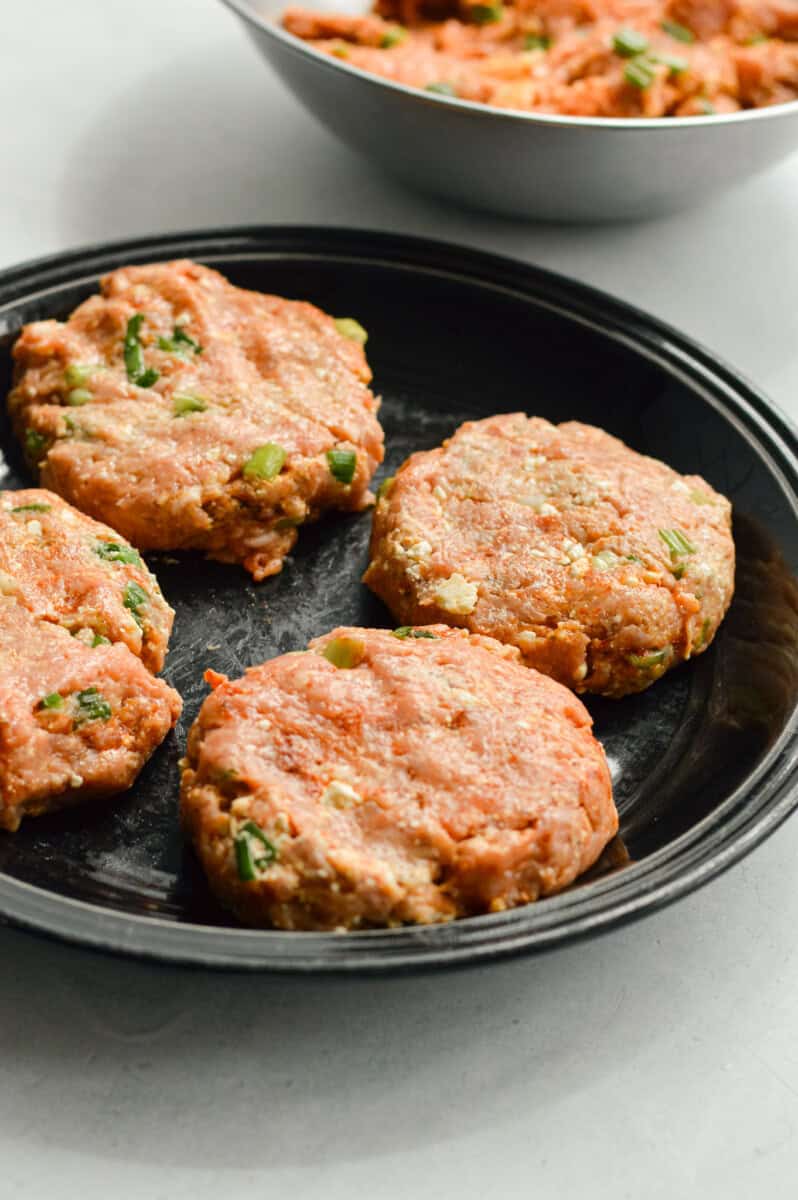 Forming chicken burger patties.