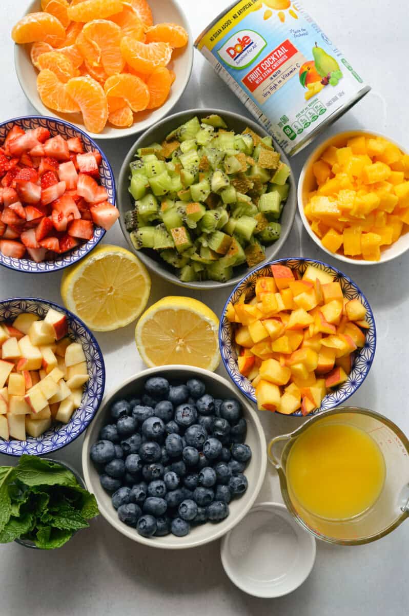 Ingredients including kiwi, strawberry, peach, apple, blueberry, lemon, honey, herbs and fruit cocktail.