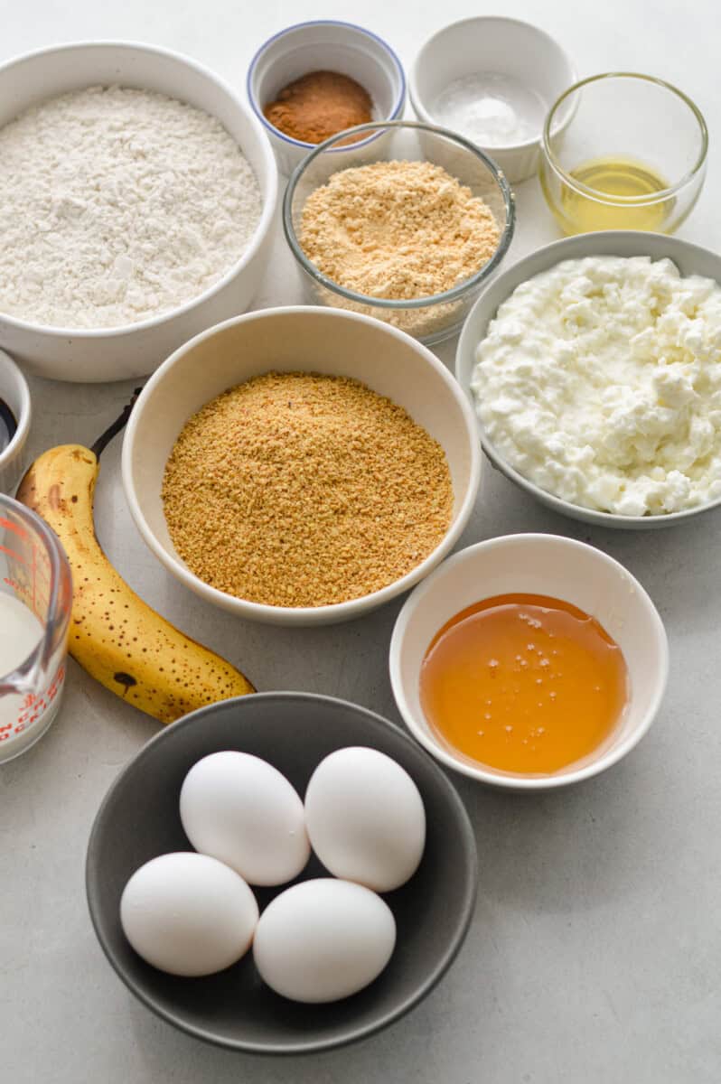 Ingredients including bananas, cottage cheese, flaxseed, peanut butter powder, milk, honey, vanilla, flour, olive oil and spices.