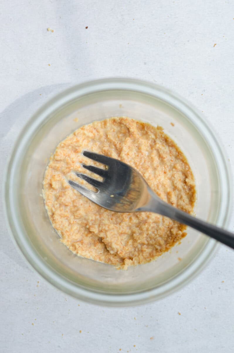 Pressing crust into the bottom of chia pudding jar.