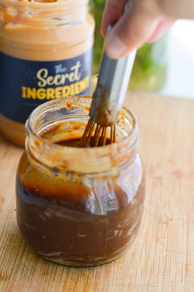 Whisking together a peanut dressing.
