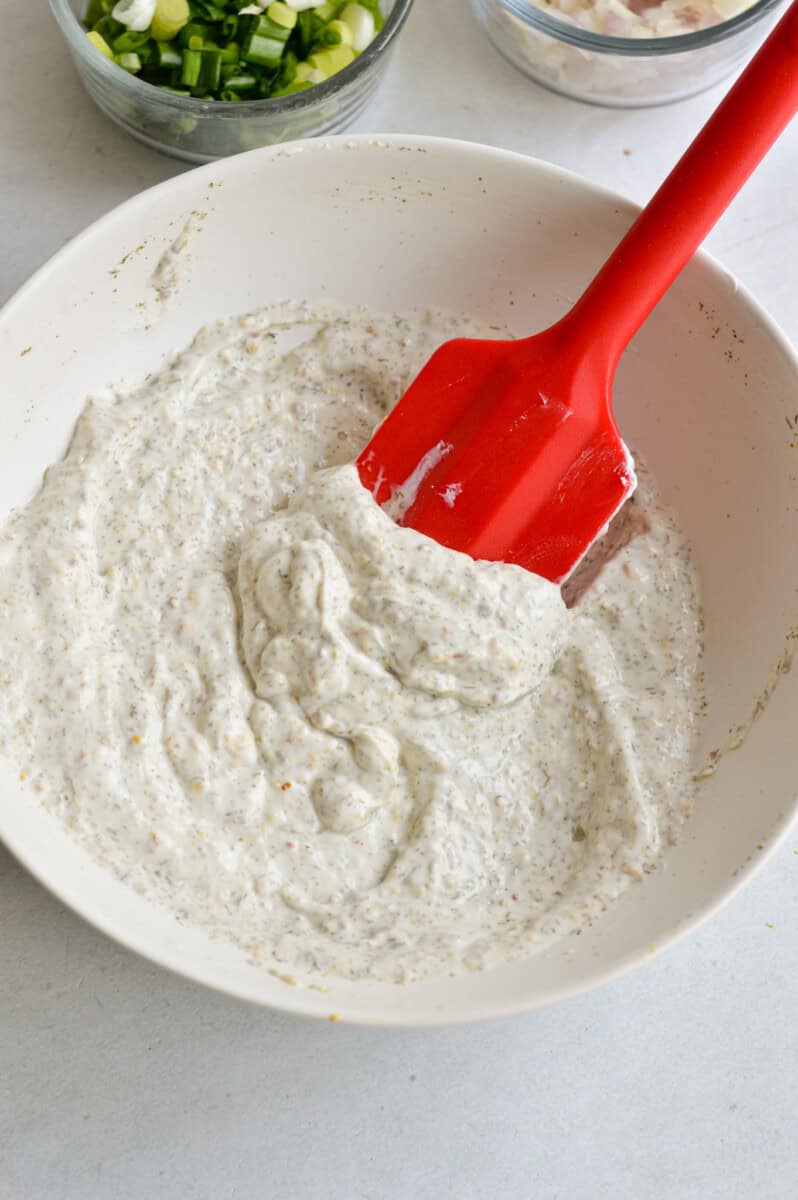Whisking together potato salad dressing.