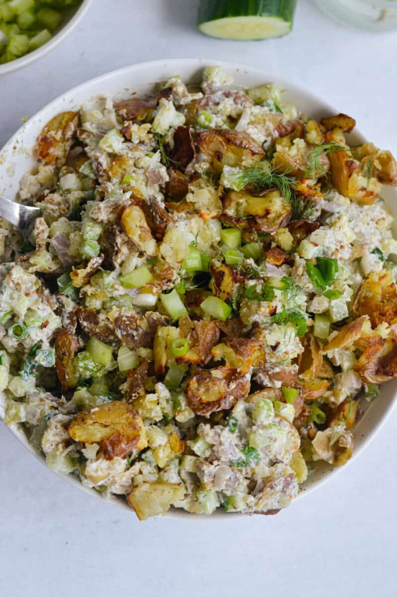 Birds eye of bowl of smashed potato salad.
