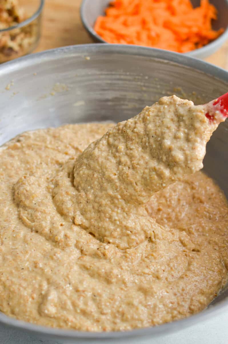 Slowly pour the blended wet ingredients into the dry ingredients, gently whisking while you are pouring to avoid clumps. Once the batter gets too thick you may need to switch to a spatula. 
