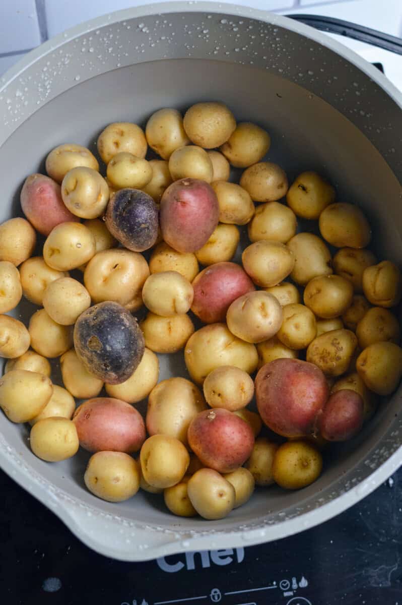 Parboiling baby potatoes.