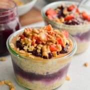 Jar of pb and j overnight oats topped with berries.